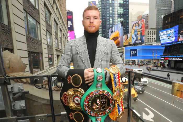 Canelo Alvarez poses for a photo in New York City and showcases his undisputed super-middleweight boxing titles.